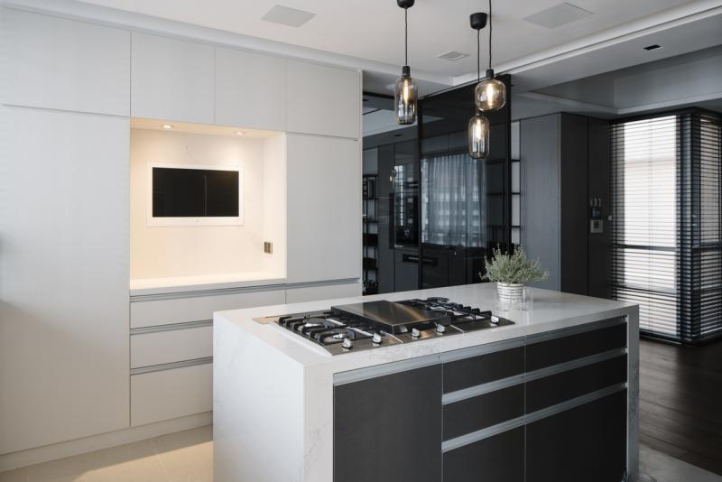 厨房和客厅之间装了一面深灰玻璃墙,让主人在厨房时也能看到客人的一举一动。