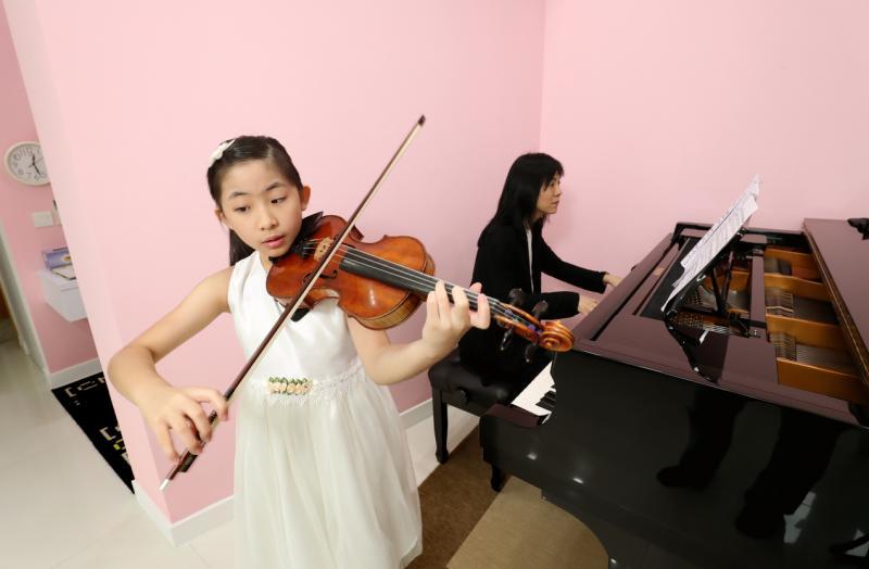 蔡珂宜和妈妈林英丽喜欢在家玩音乐。
