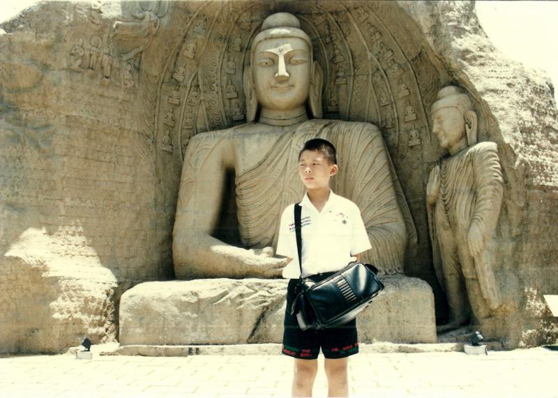 父母利用旅行的机会让陈俊元了解“有付出才会有收获”的道理,他们要他负责看管相机包以换取零用钱。(受访者提供)