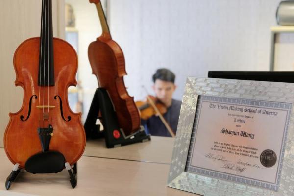 每一把小提琴的琴桥上刻有王韶军的英文名字缩写“SJ”,说明了他对自己制作的重视。