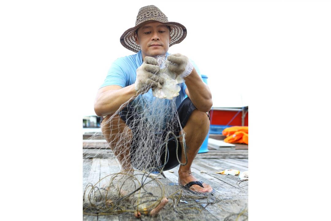 小时候的家靠海，让阿哥练就捕鱼的本领，长大后也喜欢出海捕鱼。（档案照）