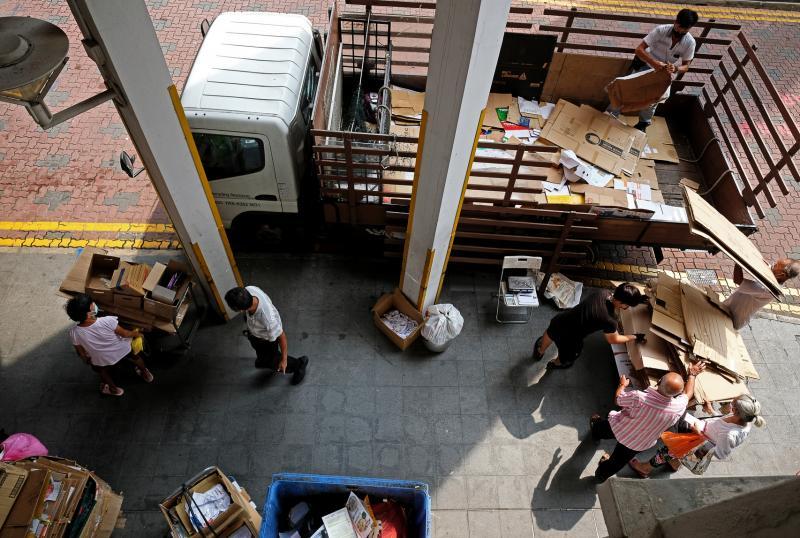 蔡姓资源回收中介商把罗厘开到牛车水,年长者陆续把收到的纸皮和铝罐等卖给他。(曾坤顺摄)