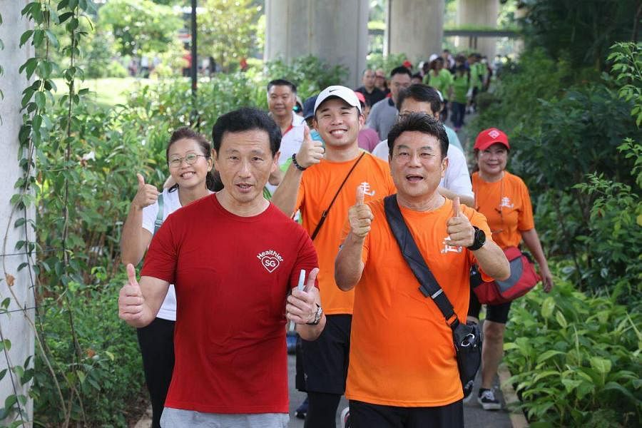 卫生部长王乙康（前左）星期六早上在三巴旺与800多人一起参加大型徒步活动。活动是与本地电影导演梁志强（前右）发起的“老朋友趴趴走”活动联合举办。（邝启聪摄）