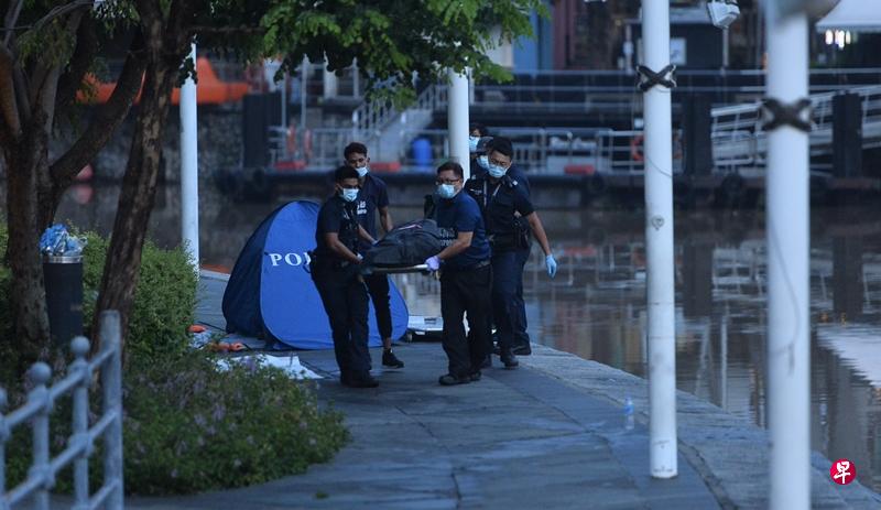 警员和仵作将尸体送上黑车。(潘丰源摄) 警员和仵作将尸体送上黑车。(潘丰源摄)