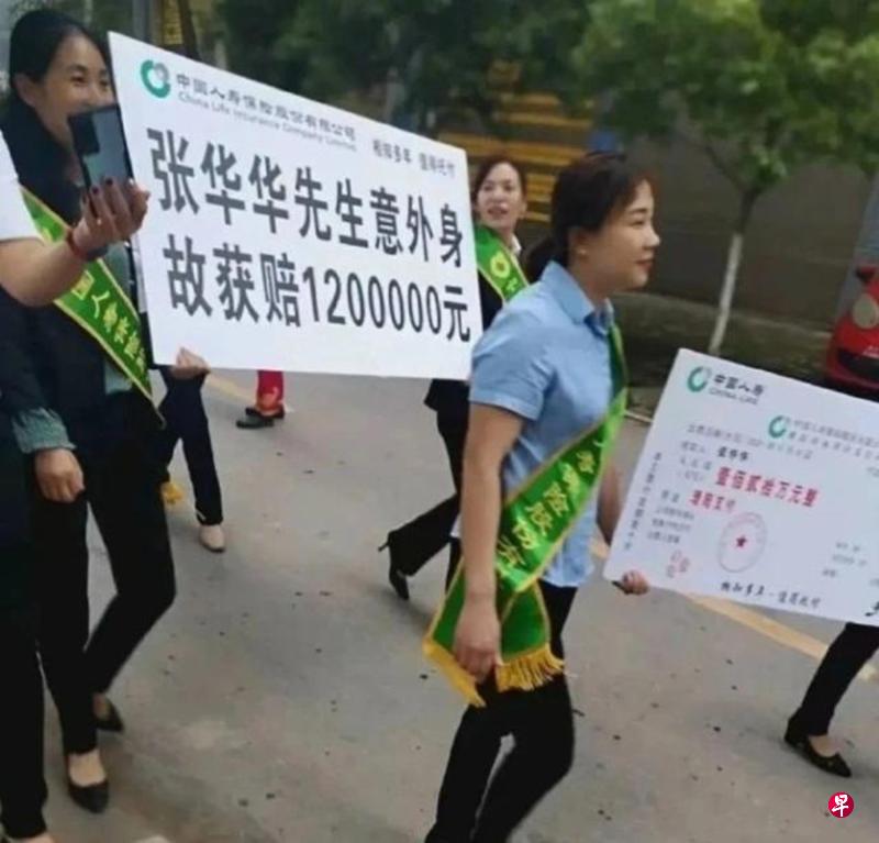 网上流传的照片显示,中国人寿员工抬着放大版的客户理赔单在街上宣传,引起公愤。(互联网) 网上流传的照片显示,中国人寿员工抬着放大版的客户理赔单在街上宣传,引起公愤。(互联网)