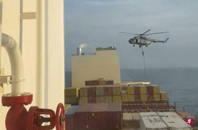 视频截图显示，4月13日，伊朗革命卫队人员以绳索从直升机迅速降落在以色列集装箱船白羊座号上。这艘船过后被带到伊朗水域。（路透社）