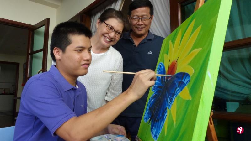陈正伟(左)自小患自闭症,刘史宁(中)与丈夫陈国兴悉心栽培他,包括让他学画画,发挥潜能。 陈正伟(左)自小患自闭症,刘史宁(中)与丈夫陈国兴悉心栽培他,包括让他学画画,发挥潜能。