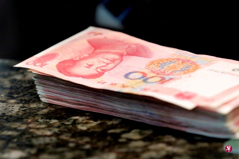 Chinese 100 yuan banknotes are seen on a counter of a branch of a commercial bank in Beijing, China. PHOTO: REUTERS Chinese 100 yuan banknotes are seen on a counter of a branch of a commercial bank in Beijing, China. PHOTO: REUTERS