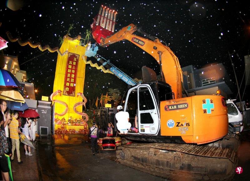 怡保斗母宫名誉主席陈耀祖周五深夜摆好祭台后,正月初九吉时一到就以挖土机将拜天公的大龙香高高举起,自己再以吊篮起重机升至约七层楼高的祭台祭拜。(星洲日报) 怡保斗母宫名誉主席陈耀祖周五深夜摆好祭台后,正月初九吉时一到就以挖土机将拜天公的大龙香高高举起,自己再以吊篮起重机升至约七层楼高的祭台祭拜。(星洲日报)