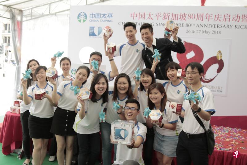 中国太平保险新加坡的员工在唐城坊户外广场义卖筹款。昨天的活动由本地艺人黄世南(黑衣者)主持。(中国太平保险提供) 中国太平保险新加坡的员工在唐城坊户外广场义卖筹款。昨天的活动由本地艺人黄世南(黑衣者)主持。(中国太平保险提供)