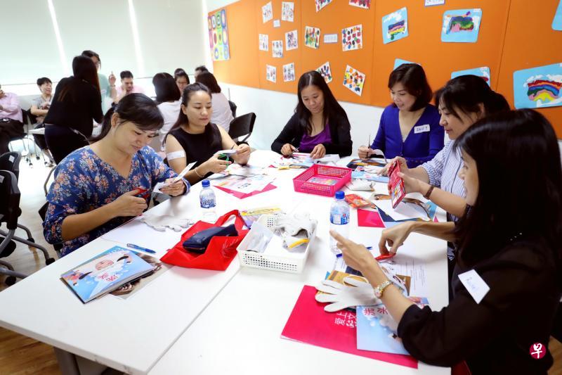 家长学习如何利用手套和人偶图片,制作手指偶来与年幼的孩子进行互动,促进孩子的语言发展。(陈来福摄) 家长学习如何利用手套和人偶图片,制作手指偶来与年幼的孩子进行互动,促进孩子的语言发展。(陈来福摄)