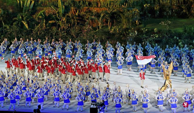 新加坡代表团在擎旗手体操运动员何和俊的带领下,步入亚运开幕式现场。(叶振忠摄) 新加坡代表团在擎旗手体操运动员何和俊的带领下,步入亚运开幕式现场。(叶振忠摄)