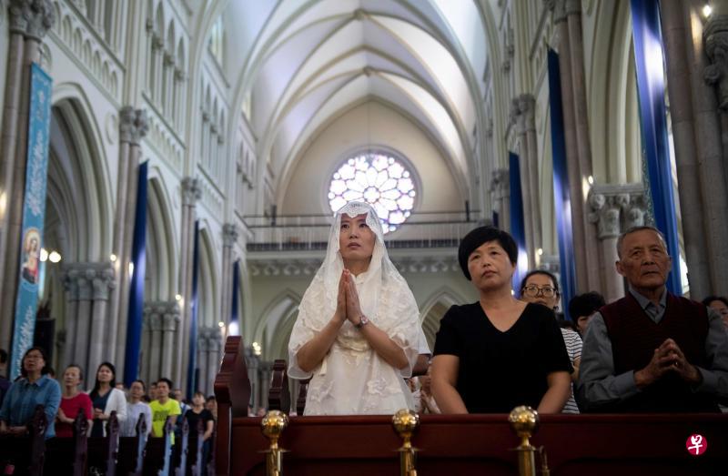 中国与梵蒂冈的双边关系近日持续回暖。图为中国信徒昨天在上海一座天主教堂内参加弥撒活动。(法新社) 中国与梵蒂冈的双边关系近日持续回暖。图为中国信徒昨天在上海一座天主教堂内参加弥撒活动。(法新社)