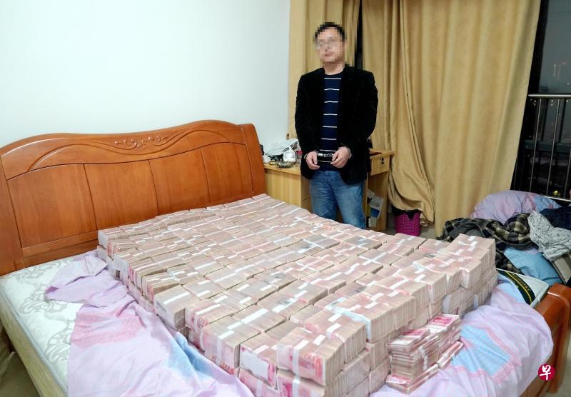 广西百色警方近日破获一起特大网络传销案,涉案金额超过8亿元人民币,图中可见警方现场起获的4700多万元人民币铺满整张床。(中新社) 广西百色警方近日破获一起特大网络传销案,涉案金额超过8亿元人民币,图中可见警方现场起获的4700多万元人民币铺满整张床。(中新社)