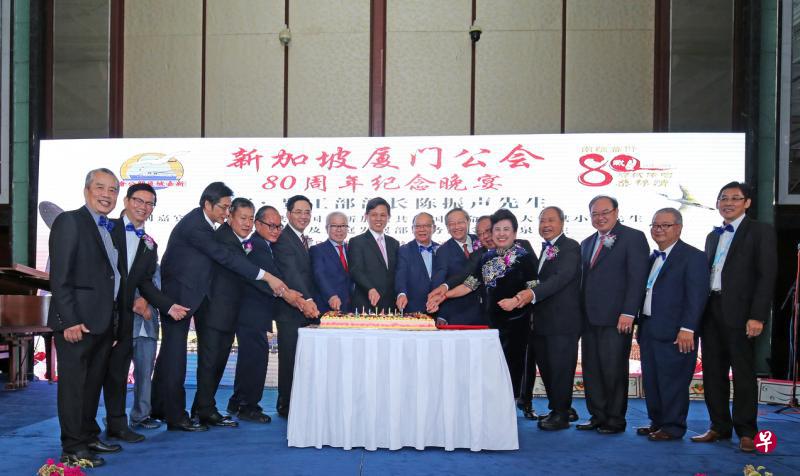 厦门公会理事和嘉宾共同切蛋糕庆祝成立80周年。左起为林玉品、杨新发医生、吴斯仁、白毅柏、曾士生、中国驻新加坡大使洪小勇、蔡天宝、贸工部长陈振声、林熙涞、社会及家庭发展部兼外交部政务部长陈振泉、黄章宜、林璒利、汪家裕、陈奕福、陈兴庭及黄伟俊。(梁麒麟摄) 厦门公会理事和嘉宾共同切蛋糕庆祝成立80周年。左起为林玉品、杨新发医生、吴斯仁、白毅柏、曾士生、中国驻新加坡大使洪小勇、蔡天宝、贸工部长陈振声、林熙涞、社会及家庭发展部兼外交部政务部长陈振泉、黄章宜、林璒利、汪家裕、陈奕福、陈兴庭及黄伟俊。(梁麒麟摄)