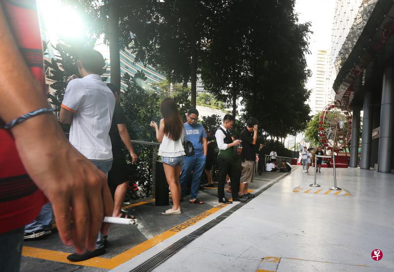 根据记者昨天下午的观察,爱雍·乌节外的一个特定吸烟区内站满烟客,有些烟客因此得站到特定吸烟区黄色格子外吸烟。(梁伟康摄) 根据记者昨天下午的观察,爱雍·乌节外的一个特定吸烟区内站满烟客,有些烟客因此得站到特定吸烟区黄色格子外吸烟。(梁伟康摄)