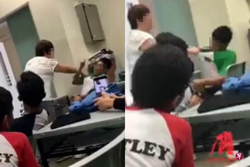 女教师拉着男学生的衣领,尝试将他拉起,想让他离开教室。(视频截图) 女教师拉着男学生的衣领,尝试将他拉起,想让他离开教室。(视频截图)