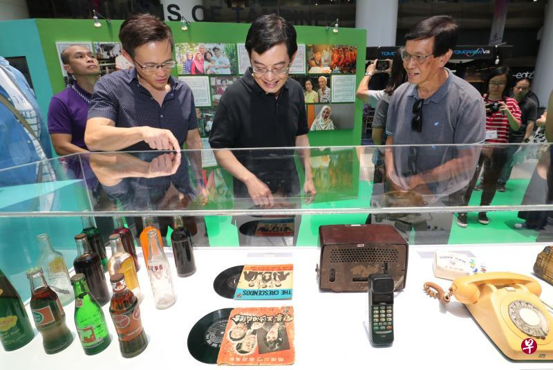 财政部长王瑞杰(中)与淡滨尼集选区议员朱倍庆(左)在淡滨尼天地举行的“我们的淡滨尼项目:我们的故事”展览,观赏展示柜里的复古日常用品。该展览讲述淡滨尼地区发展史,由10名初级学院毕业生所筹备。(陈来福摄) 财政部长王瑞杰(中)与淡滨尼集选区议员朱倍庆(左)在淡滨尼天地举行的“我们的淡滨尼项目:我们的故事”展览,观赏展示柜里的复古日常用品。该展览讲述淡滨尼地区发展史,由10名初级学院毕业生所筹备。(陈来福摄)