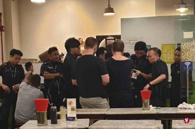 事件惊动警方上门调查,洋汉留在小吃馆接受问话。(读者提供) 事件惊动警方上门调查,洋汉留在小吃馆接受问话。(读者提供)