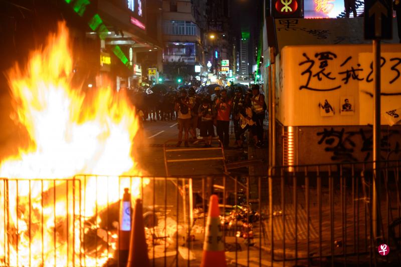 香港政务司司长张建宗表示港府官员将进入社区与市民对话不是在做“公关秀”。图为旺角7日晚上再度发生警民冲突,示威者在街边围栏旁纵火。(法新社) 香港政务司司长张建宗表示港府官员将进入社区与市民对话不是在做“公关秀”。图为旺角7日晚上再度发生警民冲突,示威者在街边围栏旁纵火。(法新社)