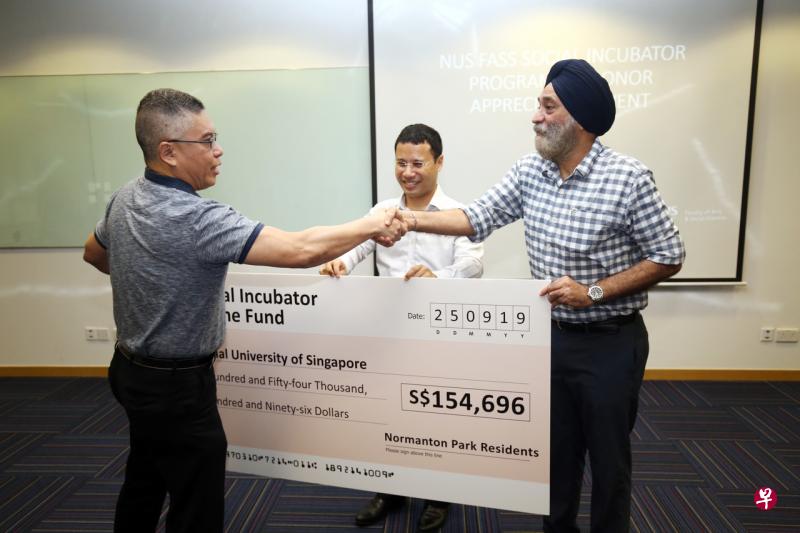 诺曼顿园前管委会主席乔普拉(右),在社会及家庭发展部长兼国家发展部第二部长李智陞(中)见证下,代表居民捐出15万4696元给国大文学暨社会科学院。左为学院院长吴文华教授。(陈斌勤摄) 诺曼顿园前管委会主席乔普拉(右),在社会及家庭发展部长兼国家发展部第二部长李智陞(中)见证下,代表居民捐出15万4696元给国大文学暨社会科学院。左为学院院长吴文华教授。(陈斌勤摄)