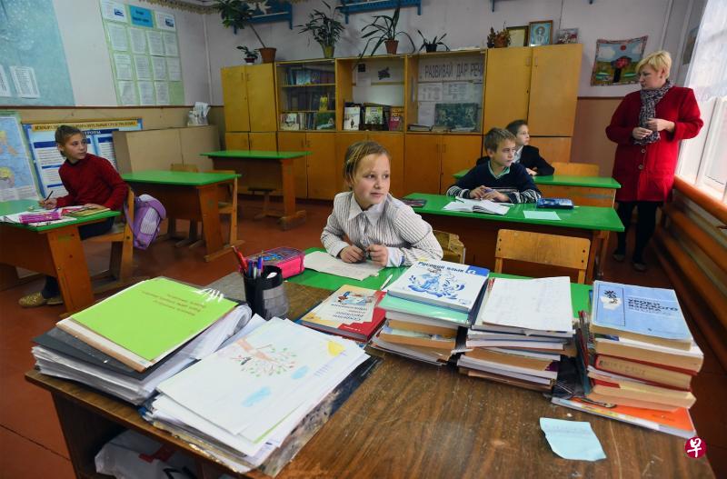 距离莫斯科以北500公里的布罗迪村的这所学校有36名学生,其中三分之一是寄养儿童,11岁的丽莎(白衣)是其中一人。(法新社) 距离莫斯科以北500公里的布罗迪村的这所学校有36名学生,其中三分之一是寄养儿童,11岁的丽莎(白衣)是其中一人。(法新社)