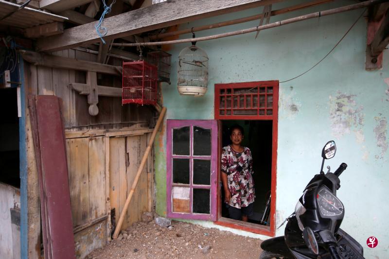 由于土地下陷,海水入侵,谭巴罗洛村米斯坎一家不得不在屋子周围堆高泥土,这一来门被挡住,只能从窗口进出。(路透社) 由于土地下陷,海水入侵,谭巴罗洛村米斯坎一家不得不在屋子周围堆高泥土,这一来门被挡住,只能从窗口进出。(路透社)