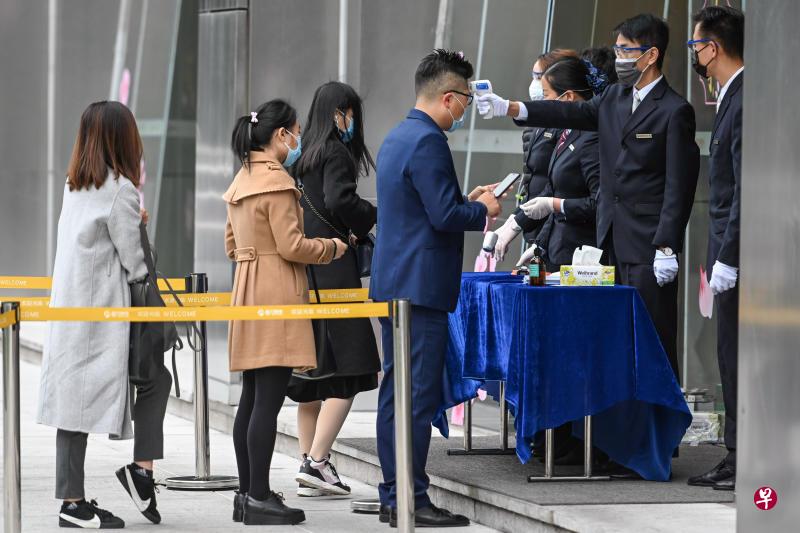 广州昨日(10日)首日复工,珠江新城中央商务区一写字楼入口处设置体温检测点,检测入楼人员体温。(中新社) 广州昨日(10日)首日复工,珠江新城中央商务区一写字楼入口处设置体温检测点,检测入楼人员体温。(中新社)