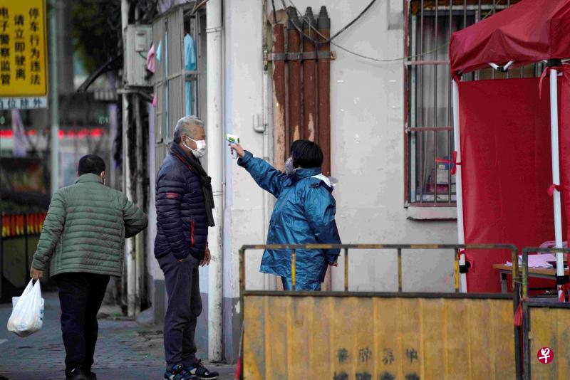 上海一街道有人检测居民体温。(路透社) 上海一街道有人检测居民体温。(路透社)