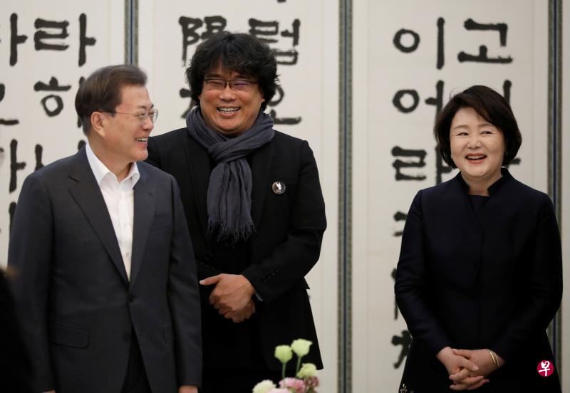导演奉俊昊(中)获韩国总统文在寅伉俪接见。(路透社) 导演奉俊昊(中)获韩国总统文在寅伉俪接见。(路透社)