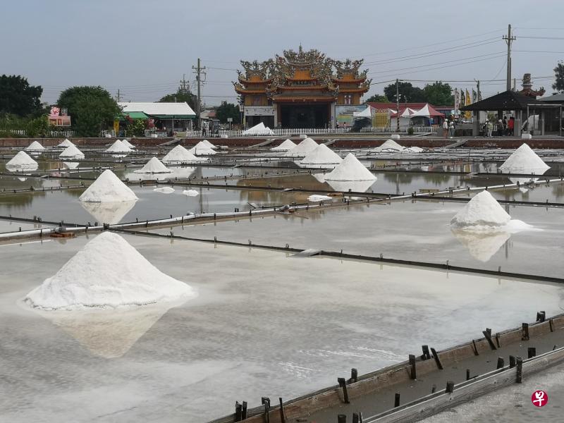 平坦盐田上,一座座雪白的盐山屹立水中央。(黄匡宁摄) 平坦盐田上,一座座雪白的盐山屹立水中央。(黄匡宁摄)