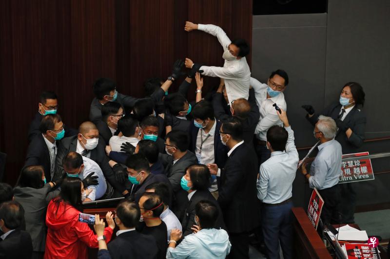 今天下午召开的香港立法会内务委员会会议还未开始，泛民和建制两派议员就在主席台前发生争执。（路透社）