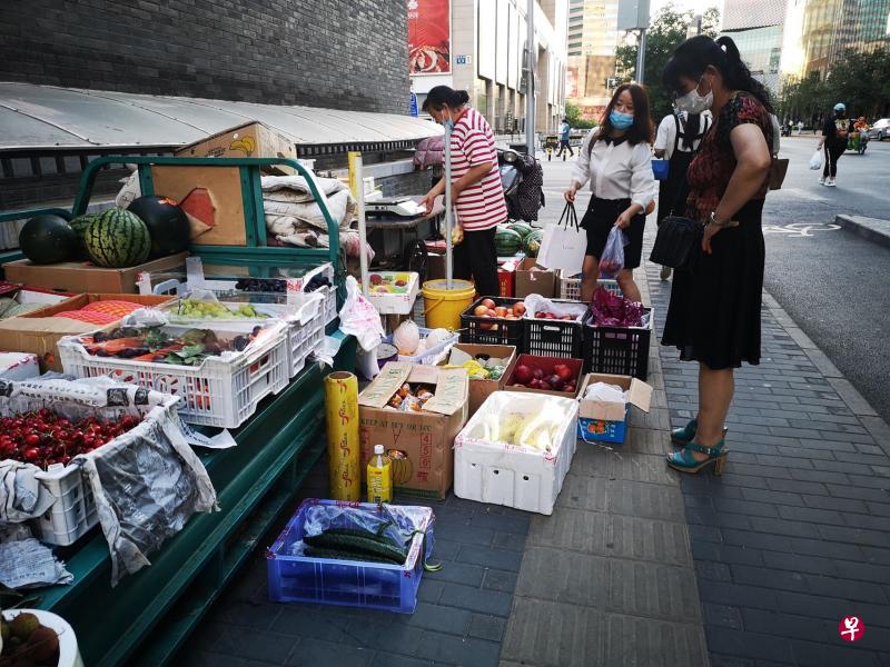 为解决低收入群体就业难题,中国最近放宽对摆地摊的管制,允许个体商户临时占道经营。图为北京崇文门附近一处背街小巷的瓜果摊。(孟丹丹摄) 为解决低收入群体就业难题,中国最近放宽对摆地摊的管制,允许个体商户临时占道经营。图为北京崇文门附近一处背街小巷的瓜果摊。(孟丹丹摄)