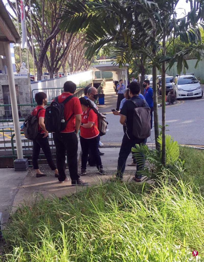 一些员工突然被裁退,在公司大门外等待职总人员协助。(读者提供) 一些员工突然被裁退,在公司大门外等待职总人员协助。(读者提供)