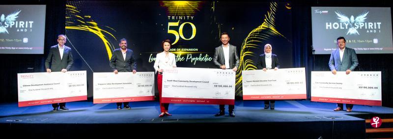 三一基督徒中心主领牧师杨德文(右三)昨晚在教会成立50周年庆祝仪式上,将各10万元的捐款支票交给五家社区机构的代表,其中包括代表西南社区发展理事会的西南区市长刘燕玲(左三)。另四家受惠机构则是华社自助理事会、新加坡印度人发展协会、回教社会发展理事会,以及关怀社区服务协会。(三一基督徒中心提供) 三一基督徒中心主领牧师杨德文(右三)昨晚在教会成立50周年庆祝仪式上,将各10万元的捐款支票交给五家社区机构的代表,其中包括代表西南社区发展理事会的西南区市长刘燕玲(左三)。另四家受惠机构则是华社自助理事会、新加坡印度人发展协会、回教社会发展理事会,以及关怀社区服务协会。(三一基督徒中心提供)