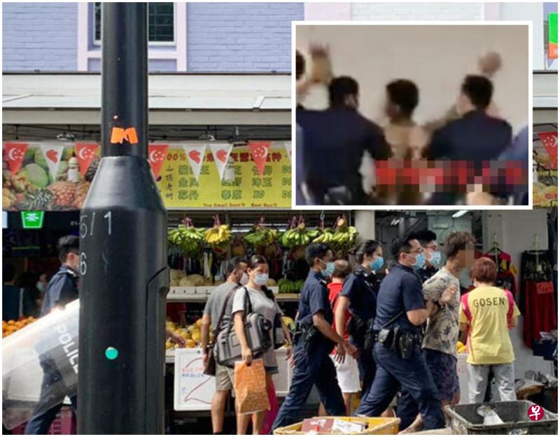文身汉不肯配合,警员好不容易才将他制服;押上警车时还不断挣扎。(读者提供) 文身汉不肯配合,警员好不容易才将他制服;押上警车时还不断挣扎。(读者提供)