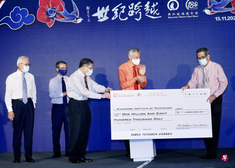福建会馆会长陈精毅(左三)昨天在活动主宾李显龙总理(左四)、特别嘉宾文化、社区及青年部长兼律政部第二部长唐振辉(左二),以及福建会馆前任会长蔡天宝(左一)的见证下,将180万元捐款支票递交给新加坡理工大学校长陈添顺教授(右一)。(陈斌勤摄) 福建会馆会长陈精毅(左三)昨天在活动主宾李显龙总理(左四)、特别嘉宾文化、社区及青年部长兼律政部第二部长唐振辉(左二),以及福建会馆前任会长蔡天宝(左一)的见证下,将180万元捐款支票递交给新加坡理工大学校长陈添顺教授(右一)。(陈斌勤摄)