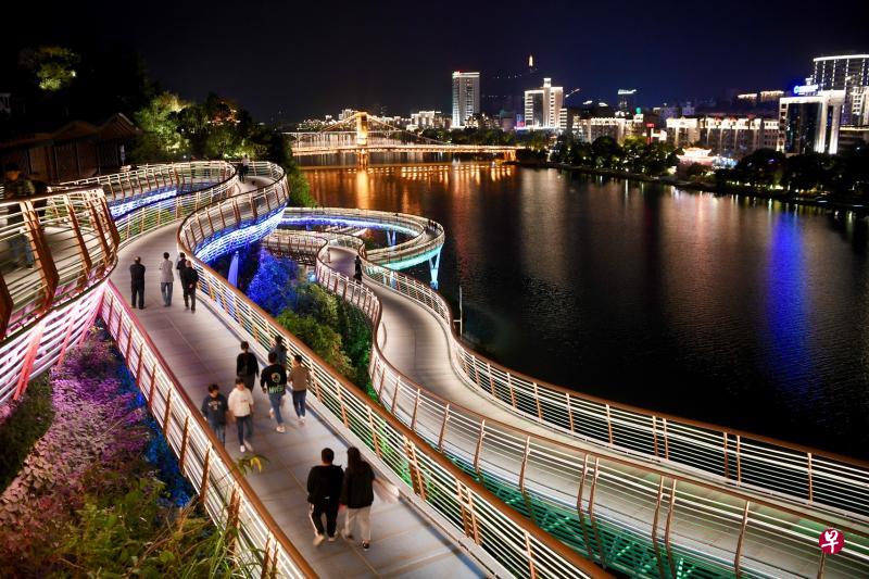 图为前晚三明市市民和游客在沙县虬龙桥栈道散步休闲。(新华社) 图为前晚三明市市民和游客在沙县虬龙桥栈道散步休闲。(新华社)