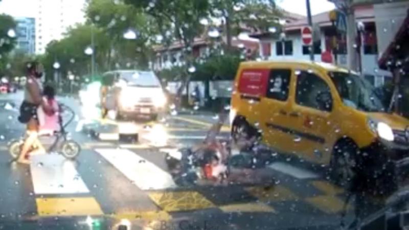 黑衣男骑着电板车载着两个小孩驶过斑马线,途中与直行货车擦撞,导致三人摔倒地上。(取自面簿) 黑衣男骑着电板车载着两个小孩驶过斑马线,途中与直行货车擦撞,导致三人摔倒地上。(取自面簿)
