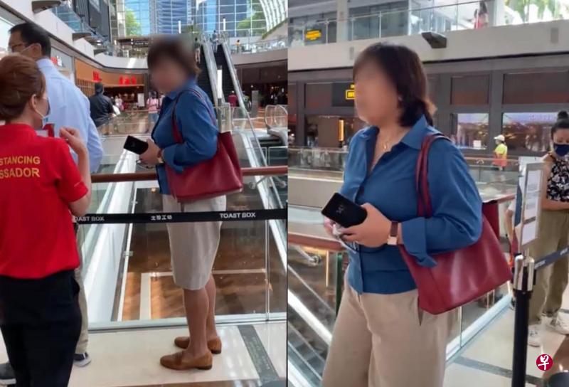 女子(蓝衣者)在安全距离大使反复提醒后,仍拒绝戴口罩。(视频截图) 女子(蓝衣者)在安全距离大使反复提醒后,仍拒绝戴口罩。(视频截图)